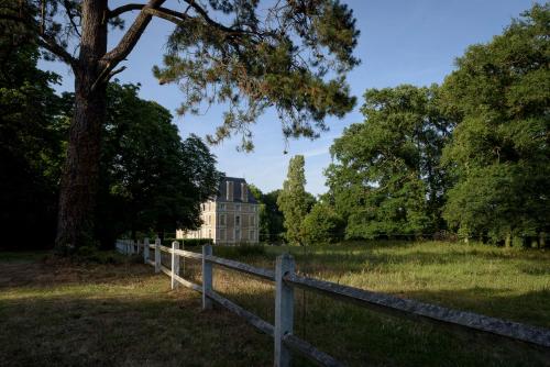 an old house in a field with a fence at Le Rossay in Saint-Clément-de-la-Place