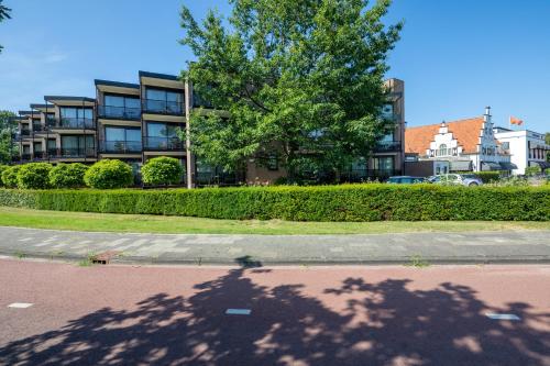 a shadow of a tree in front of a building at Van der Valk Hotel Leiden in Leiden