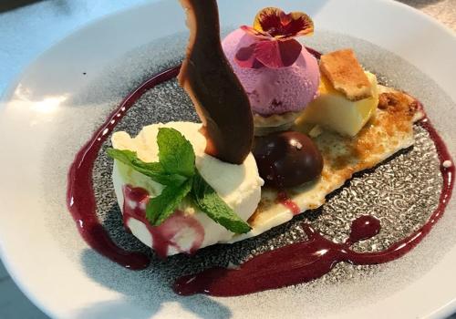a dessert on a plate with ice cream and fruit at BQ Paguera Boutique Hotel - Adults Only in Paguera