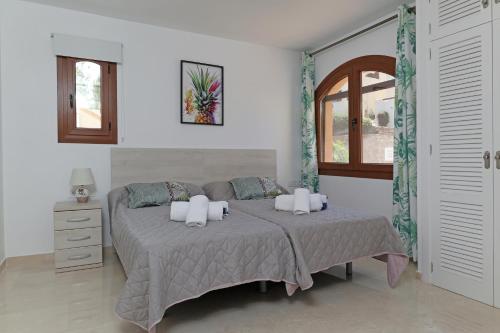 a bedroom with a bed and a window at Las Palmeras 4 with rooftop solarium and fiber optic internet in Atamaría