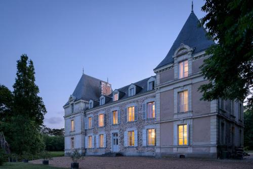an old mansion with its lights on at Le Rossay in Saint-Clément-de-la-Place