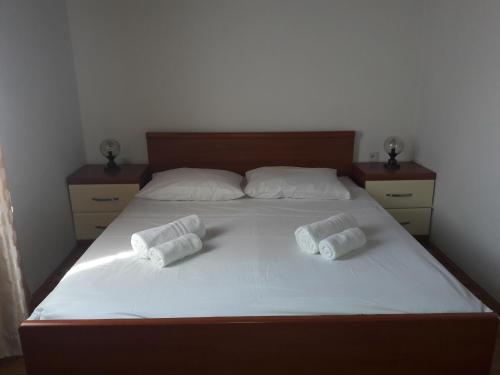 a bedroom with a bed with two pillows on it at Small apartment Merica in Novalja