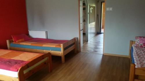 a room with two beds and a hallway at Pokoje Gościnne "U Karola" Pracownicze in Ścinawa