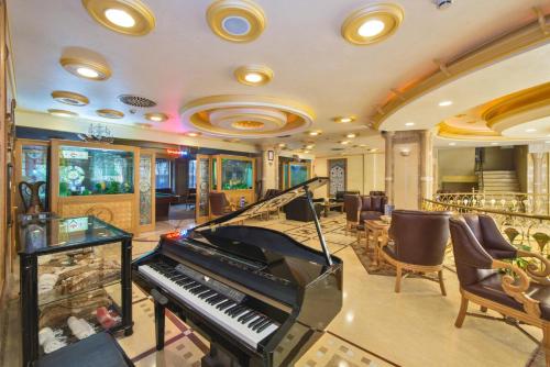 a living room with a piano and a bar at Wyndham Istanbul Old City in Istanbul