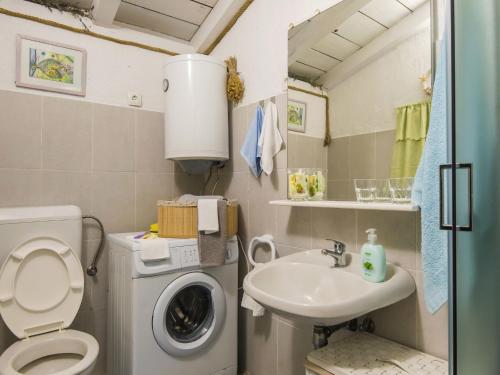 a small bathroom with a washing machine and a sink at Holiday Home near Adriatic Sea and Krka Falls in Šopot