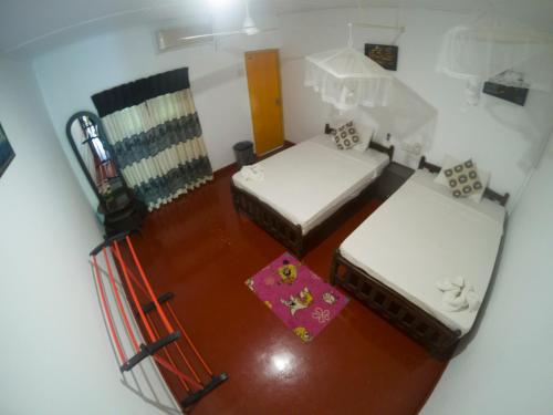 an overhead view of a room with two beds at Palitha Homestay in Sigiriya