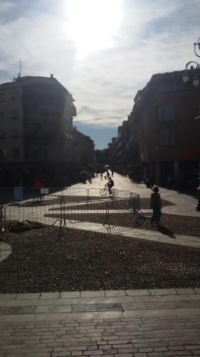 a person riding a bike on a city street at B&B Honey Rooms in Saronno