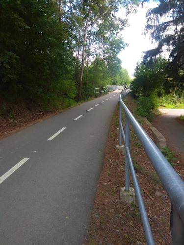 a road with a fence on the side of it at NOVODVORSKÝ APARTMÁN SÁRA in Nové Dvory