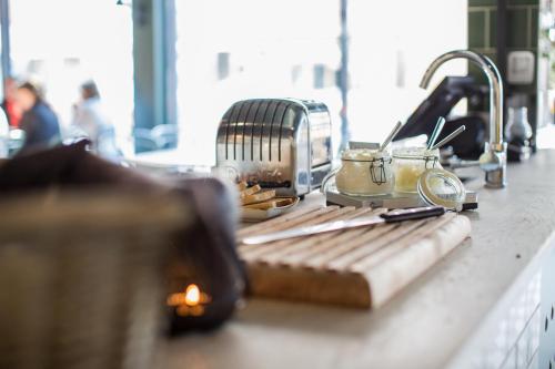 a kitchen counter with a cutting board and a toaster at Best Western Plus Hus 57 in Ängelholm