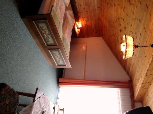 an attic room with a staircase with a window and lights at Naturgut Gailtal in Sankt Stefan an der Gail