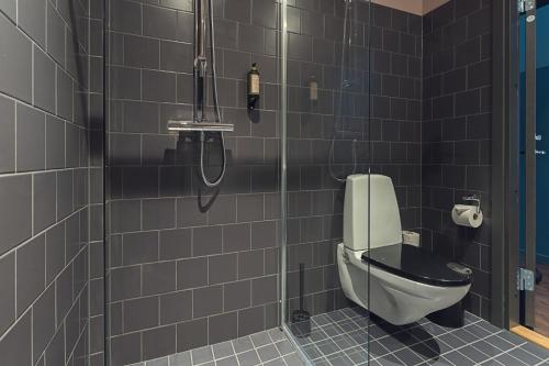 a bathroom with a toilet and a shower at Best Western Plus Hus 57 in Ängelholm