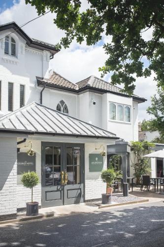 a store front of a white building at George Hotel, BW Signature Collection in Norwich
