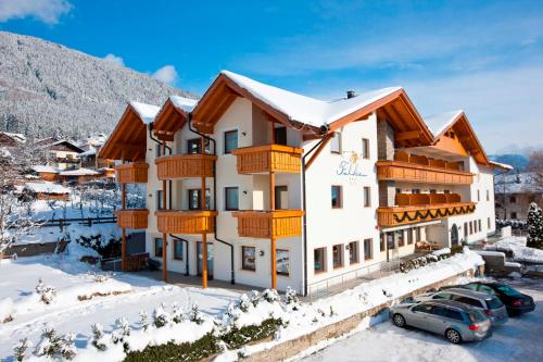 a hotel in the mountains with snow on the ground at Hotel Falken in Falzes