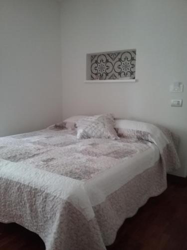 a bedroom with a bed with a blanket on it at Rivamare San Terenzo in Lerici