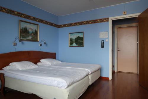 En eller flere senger på et rom på Hotel Aveny Bed & Breakfast