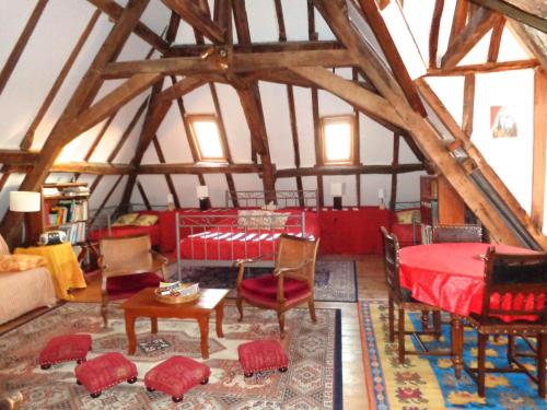 a living room with a red table and chairs at Château d'Avanton in Avanton
