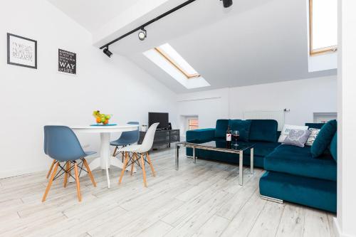 a living room with a blue couch and a table at DIETLA 99 APARTMENTS - IDEAL LOCATION - in the heart of Krakow in Kraków