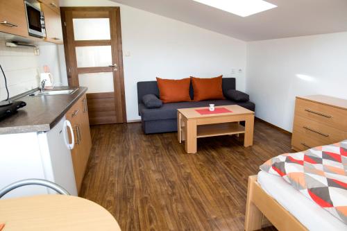 a small living room with a couch and a table at Penzion Starobor in Sedlice