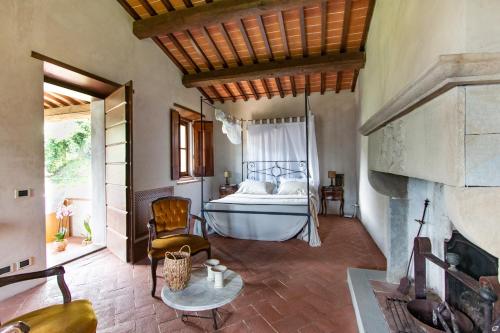 a bedroom with a bed and a fireplace at Villa Doriana in Camaiore