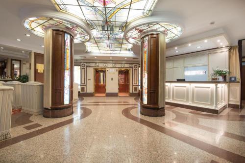 a lobby with a building with a stained glass ceiling at Hotel Downtown in Sofia