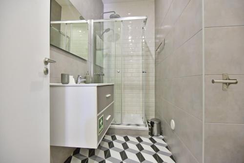 a white bathroom with a sink and a shower at TryLisbon Calvário in Lisbon