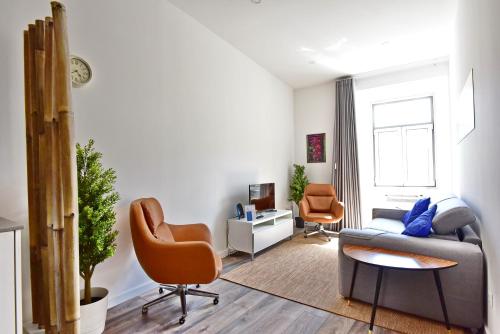 a living room with a couch and a chair at TryLisbon Calvário in Lisbon