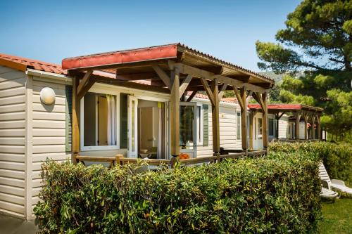a house with a gazebo on top of it at Valamar Camping Padova in Rab