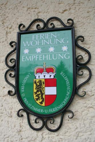 a sign on the side of a building at Apartments Landhaus Sonnheim in Lofer