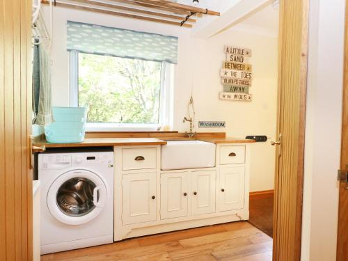 a laundry room with a washer and dryer at Westhaven in Mallaig