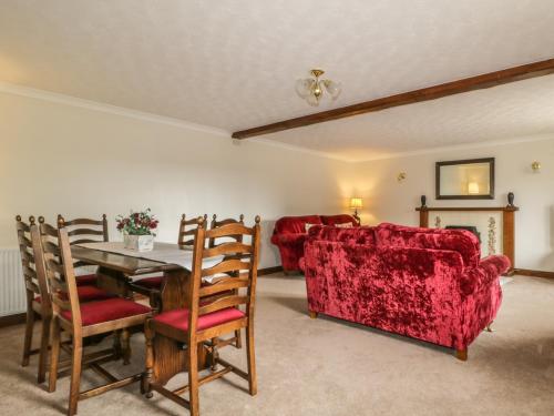 a living room with a table and a couch at Woodhead Farm Cottage in Penrith