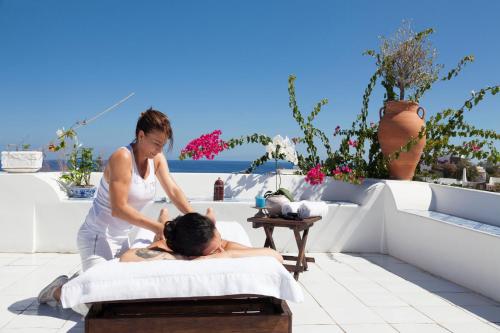 a woman is giving a man a massage on a bed at Quartara Boutique Hotel in Panarea
