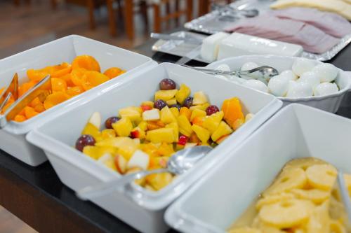 three bowls of fruit and vegetables on a table at Avenida de Fatima in Fátima