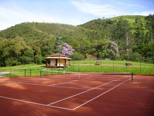 a tennis court with a gazebo on it at Pousada Kolibri in São Francisco Xavier