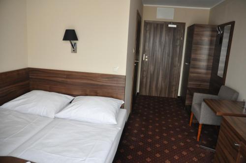 Ένα ή περισσότερα κρεβάτια σε δωμάτιο στο Hotel Morze