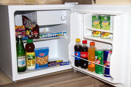 an open refrigerator filled with drinks and snacks at Damla Hotel Baku in Baku