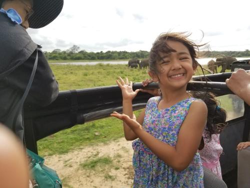 a little girl standing in front of a vehicle at Nelu Villa Sigiriya in Sigiriya