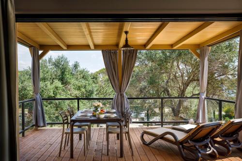 a screened in porch with a table and chairs at Valamar Camping Padova in Rab