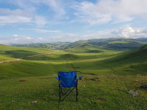 a blue chair sitting on top of a green field at TAŞ KONAK BUTİK OTEL in Ordu