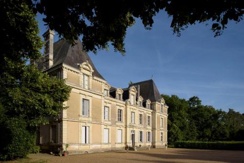 a large brick building with a tower on top at Le Rossay in Saint-Clément-de-la-Place