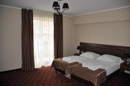 Ένα ή περισσότερα κρεβάτια σε δωμάτιο στο Hotel Morze
