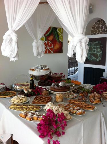 a table with a buffet of food on it at Quartara Boutique Hotel in Panarea