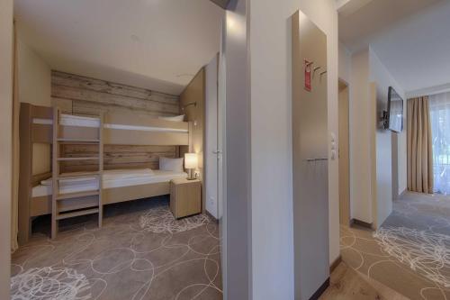 a room with two bunk beds and a hallway at Aquamaris Strandresidenz Rügen in Juliusruh