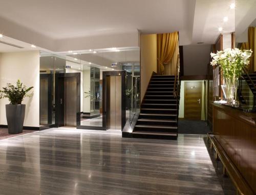 a lobby with a staircase in a building at LH Hotel Sirio Venice in Mestre