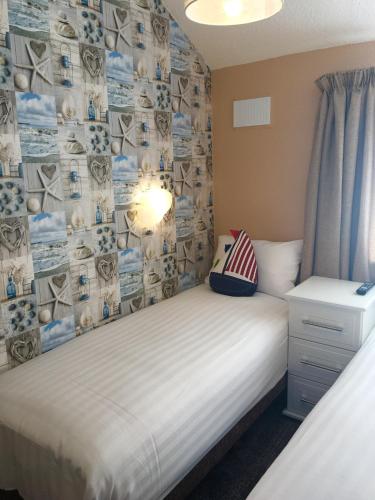 a small bedroom with a bed and a curtain at Corona Blackpool in Blackpool