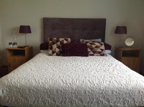a bedroom with a large white bed with pillows at The Well Bed & Breakfast in Clonakilty