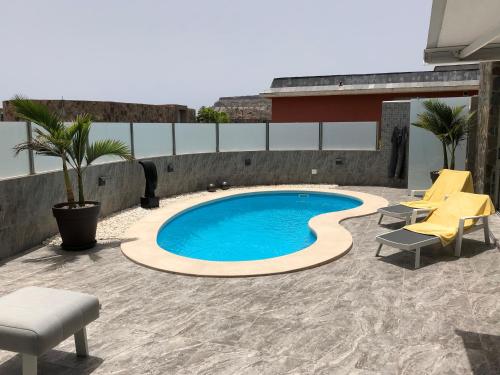 a swimming pool on the roof of a building at Suecia Villa Opal Anfi Tauro in Mogán