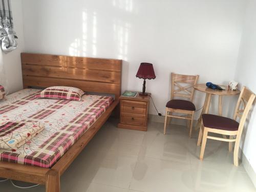 Ένα ή περισσότερα κρεβάτια σε δωμάτιο στο Thom's Homestay
