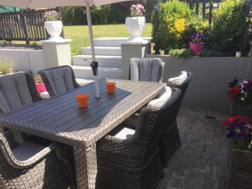 a wooden table with chairs and an umbrella at The Well Bed & Breakfast in Clonakilty