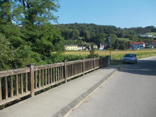 a car parked on a road next to a fence at Gasthaus Kleebinder in Haunoldstein