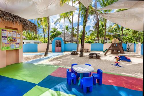 a play area with a table and chairs and a playground at Catalonia Punta Cana - All Inclusive in Punta Cana